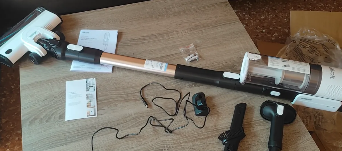 Levoit LVAC-200 cordless vacuum laid out with its floorhead, charger and supplied tools